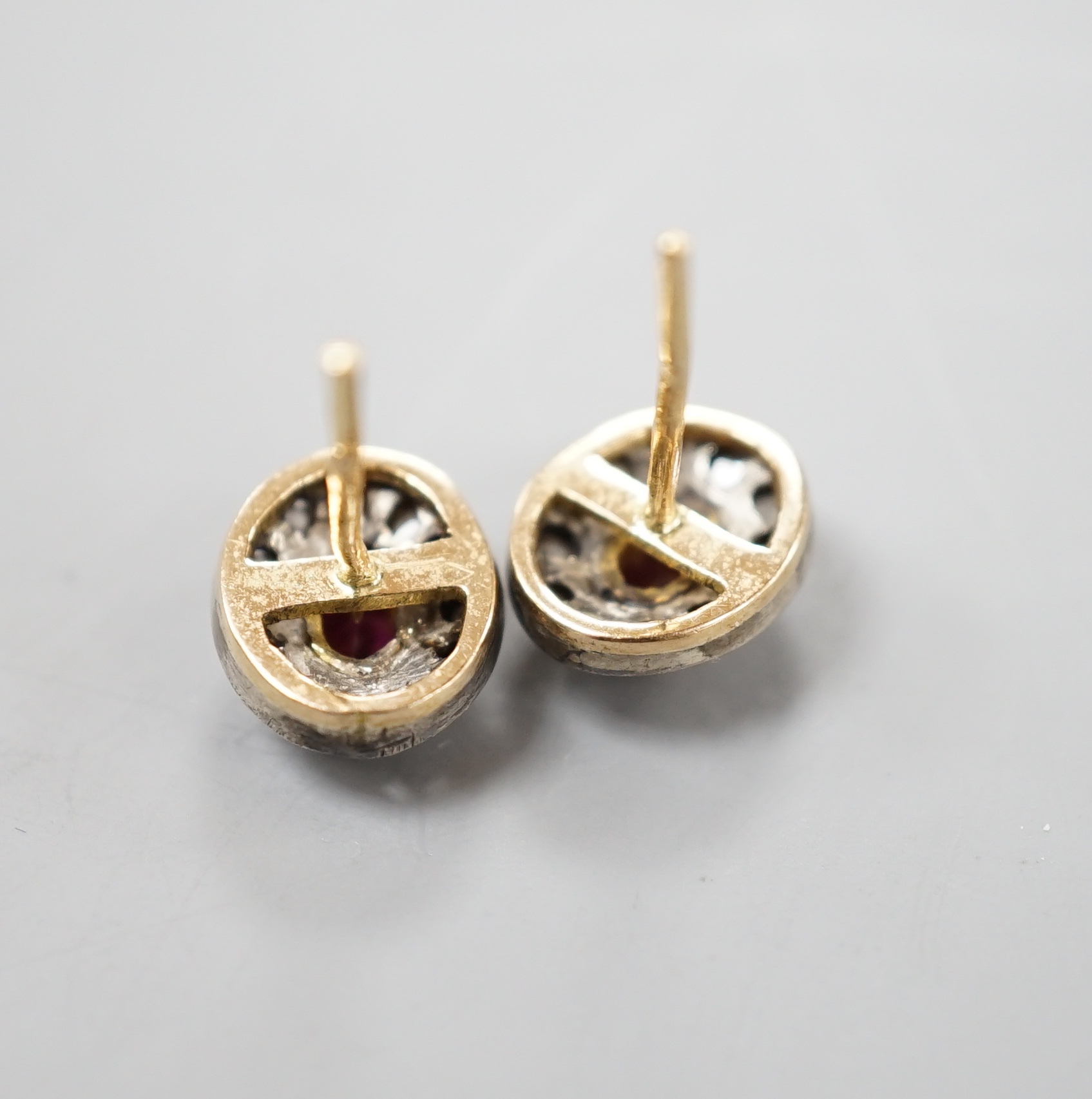 A pair of yellow metal, ruby and rose cut diamond set oval cluster earrings, 10mm, gross 3.2 grams.